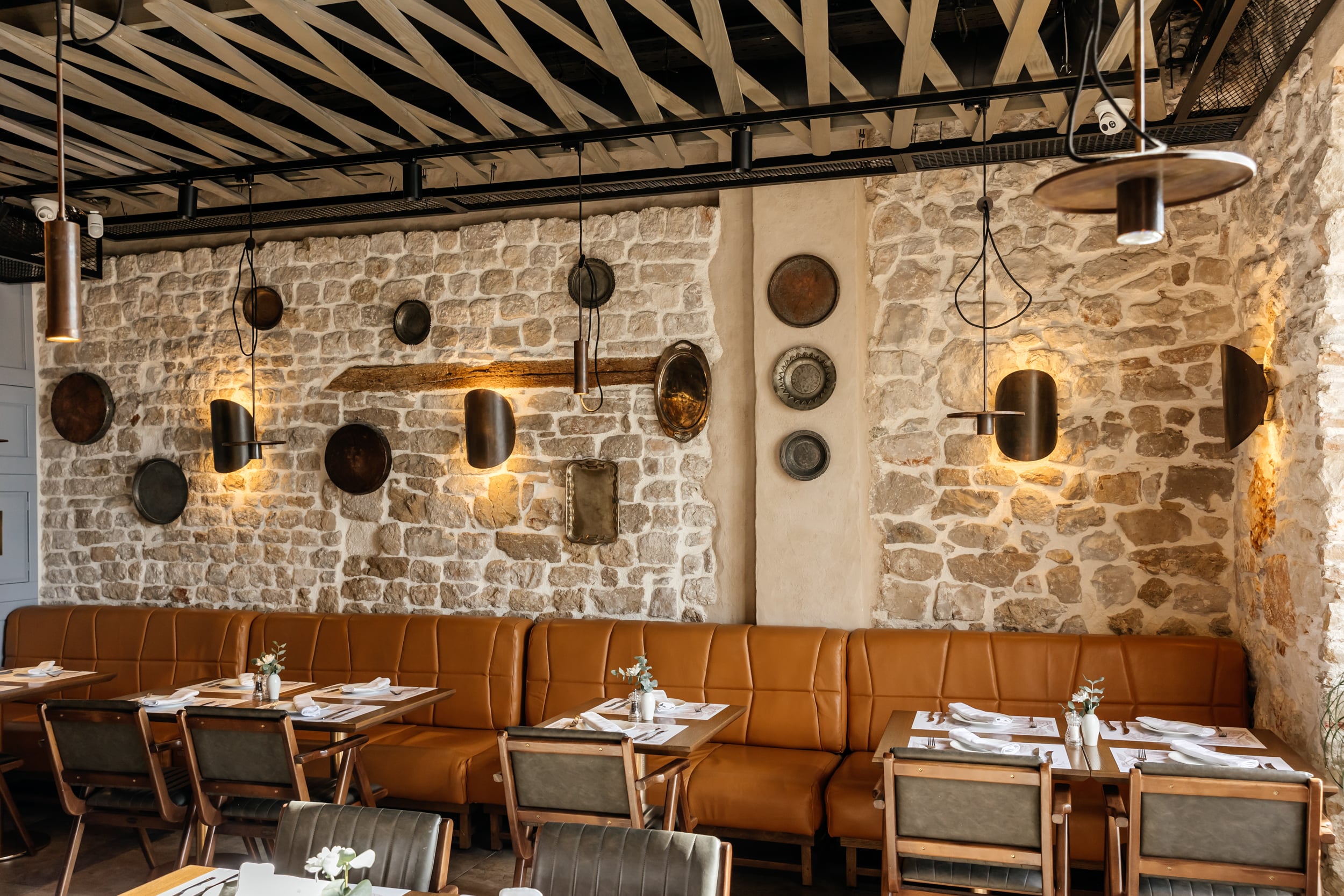 Dining tables beneath the restored stone Bilinić Arch at Buta.