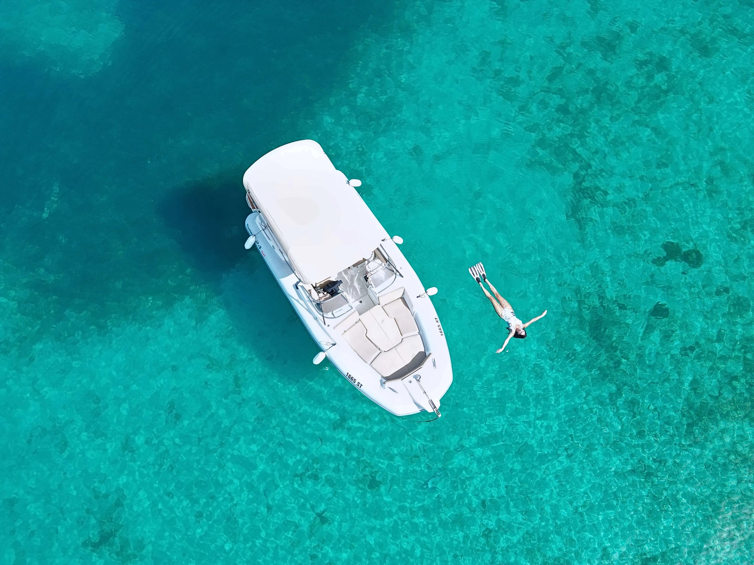 A private boat beside clear Adriatic water.