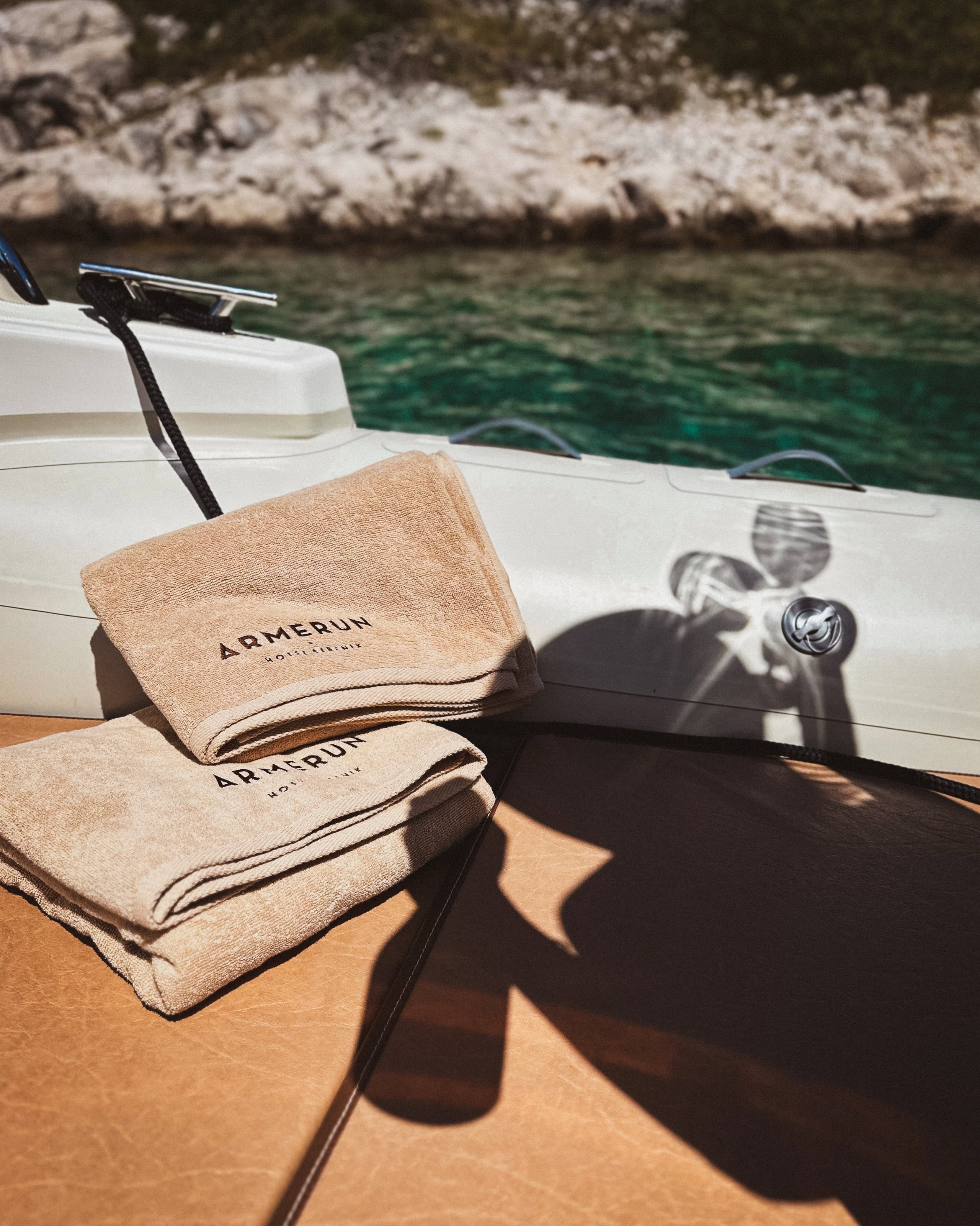 Armerun towels on a private boat beside the coast.