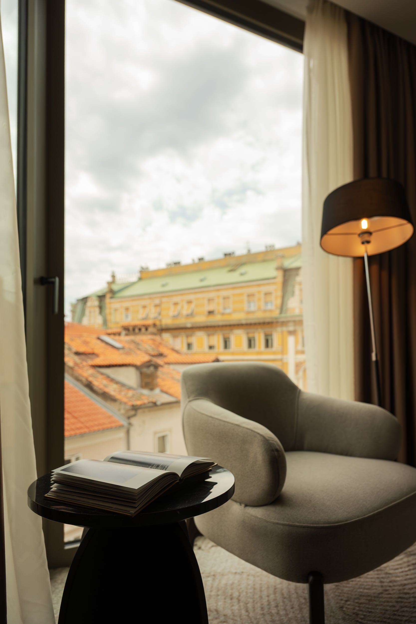 Reading chair beside the city-facing window in Armerun Rijeka room 405.