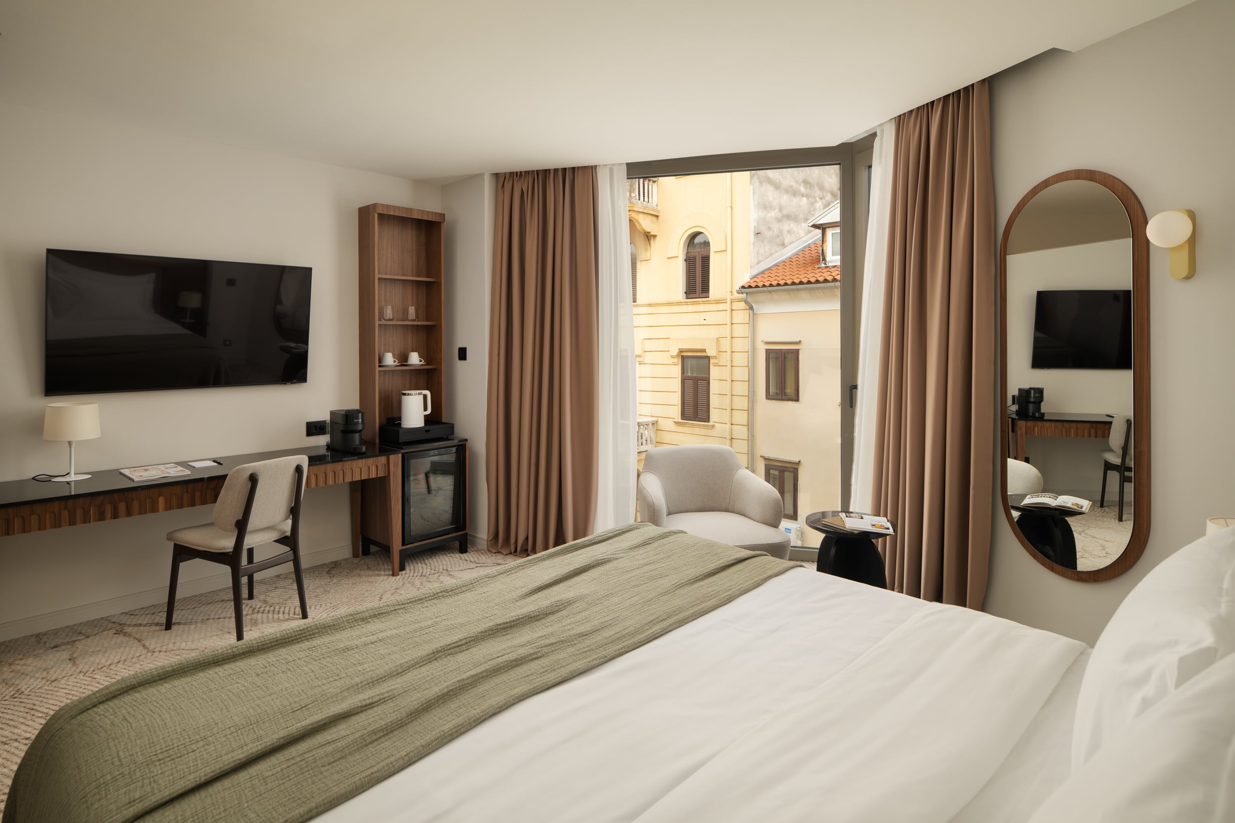 Armerun Rijeka room 305 with a double bed and city view.