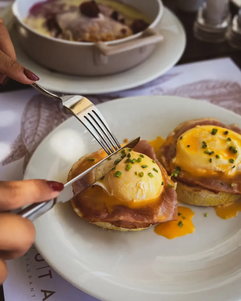 Eggs Benedict served on toasted bread.