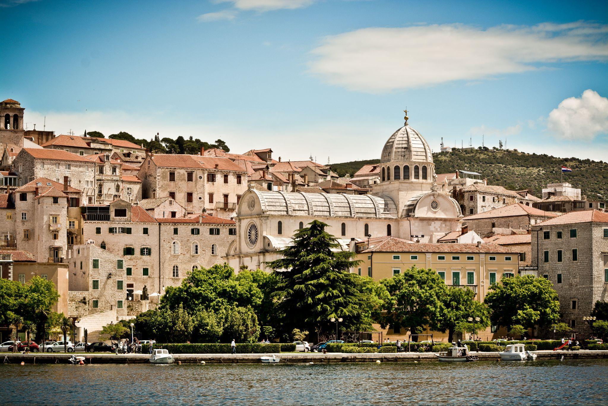 Šibenik waterfront and historic stone architecture seen from the sea.